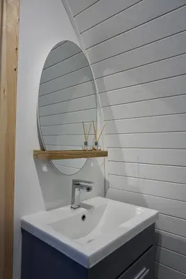 a bathroom with a white sink and a mirror at Eastridge Glamping Pods in Shrewsbury