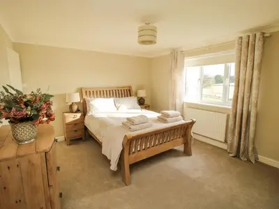 a bedroom with a bed and a window at The Marshes in Welshpool