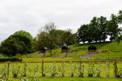 a field with some huts on top of a hill at Heron in Nantmel