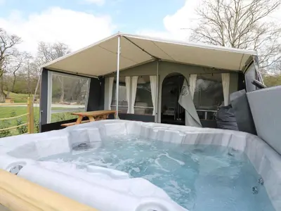 a hot tub with a tent in the background at King Fisher in Nantmel