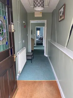 a hallway with a stairway with a door and a room at The Coach House at Copper Hall in Leominster