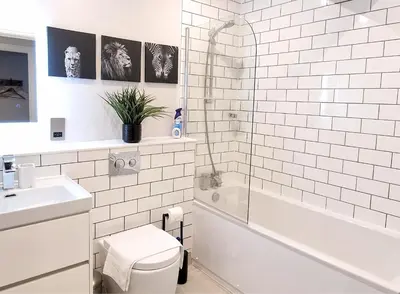 a white bathroom with a toilet and a sink at The Academy House by Bevolve in Shrewsbury