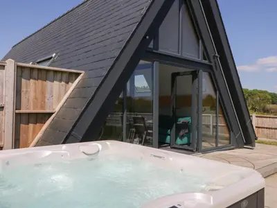 a hot tub in front of a house at Elan Valley Welsh - The Sheepfold in Llandrindod Wells