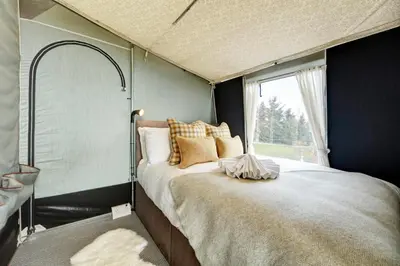 a bedroom with a large bed with a window at Salmon in Nantmel