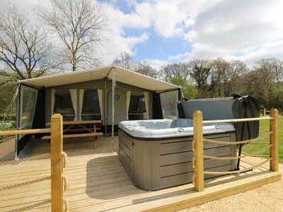 a tent with a hot tub on a deck at Salmon in Nantmel