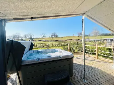 a hot tub on a deck with a view at Salmon in Nantmel
