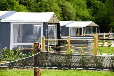 a group of tents in a yard with a net at Otter in Nantmel