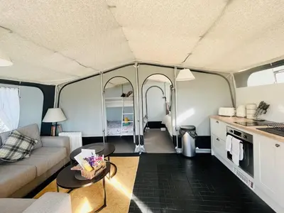 a living room with a couch and a table in a tent at Otter in Nantmel