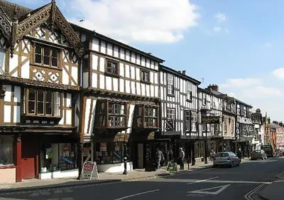 a row of buildings on a street with a car at Corve Cottage Historic cottage in beautiful ludlow in Ludlow