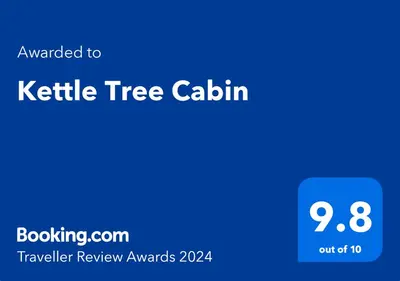 a blue sign with the text kettle tree calium at Kettle Tree Cabin in Welshpool
