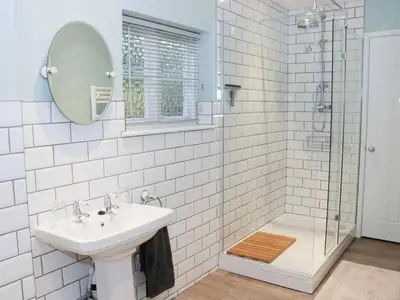 a white bathroom with a sink and a shower at Divine, detached countryside cottage near Ludlow. in Ludlow
