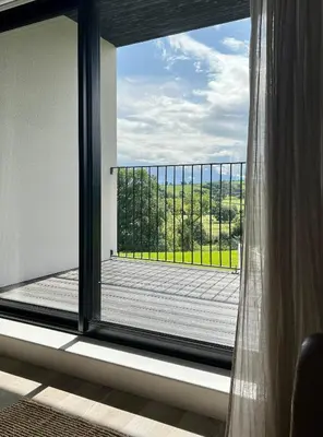 a window with a view of a wooden deck at The Loft Studio apartment - above detached new build garage in Llanymynech