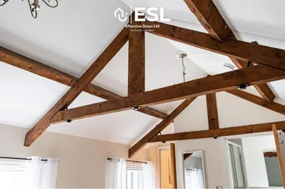 a room with wooden beams on the ceiling at Super Central - Quiet - 2 Bedroom Cottage in Shrewsbury