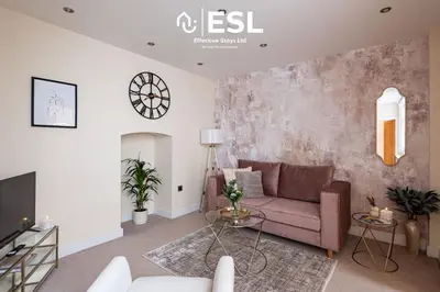 a living room with a couch and a tv at Super Central - Quiet - 2 Bedroom Cottage in Shrewsbury
