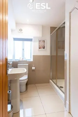 a bathroom with a toilet and a sink and a shower at Super Central - Quiet - 2 Bedroom Cottage in Shrewsbury