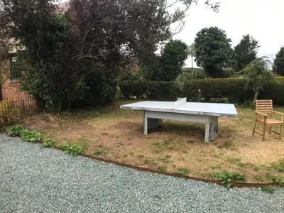 a picnic table in a yard with a bench at ryton grange church barn sleeps 5 in Shrewsbury
