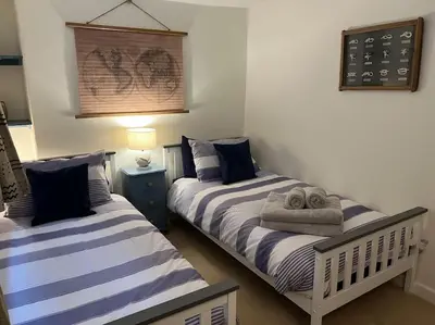 two beds sitting next to each other in a bedroom at Harbourside 2 Bed apartment, Barmouth Bridge Views in Barmouth