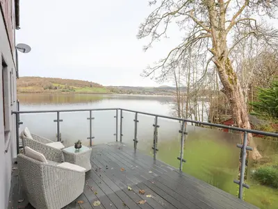 a balcony with a view of a lake at Vyrnwy Lakeside - Bala Lake in Bala