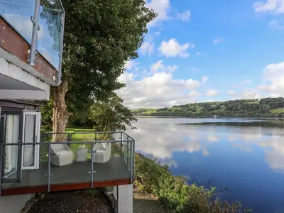 a balcony of a house with a view of a lake at Drysgol Lakeside - Bala Lake in Bala