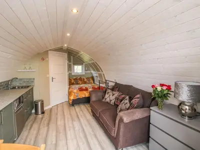 a living room with a couch and a bedroom at Cherry Pod 2 in Shrewsbury