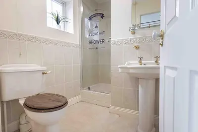 a bathroom with a toilet and a sink at Spacious house in quiet cul-de-sac near to Hospital in Shrewsbury