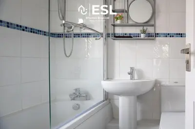 a white bathroom with a sink and a shower at Luxurious 2 Bedroom Countryside Hot Tub Retreat in Stiperstones in Shelve