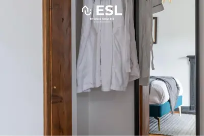 a closet with a door with clothes hanging on it at Luxurious 2 Bedroom Countryside Hot Tub Retreat in Stiperstones in Shelve