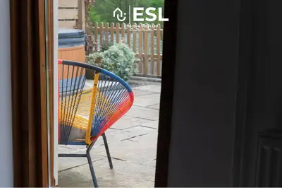 a colorful chair sitting outside of a door at Luxurious 2 Bedroom Countryside Hot Tub Retreat in Stiperstones in Shelve