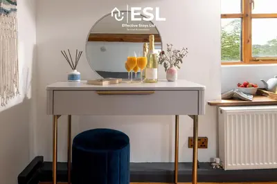 a dressing table with a mirror and a blue stool at Luxurious 2 Bedroom Countryside Hot Tub Retreat in Stiperstones in Shelve