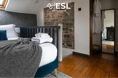 a bedroom with a bed with towels on it at Luxurious 2 Bedroom Countryside Hot Tub Retreat in Stiperstones in Shelve