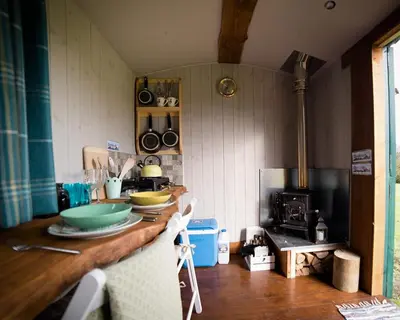 a kitchen with a counter with bowls on it at Shire the Shepherd's Hut at Pentref Luxury Camping in Penuwch