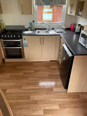 a kitchen with a sink and a stove top oven at Van number 123 Beautiful Caravan sleeps 4 in Aberystwyth