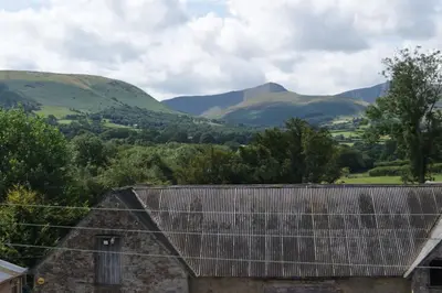 a view of mountains from the roof of a house at Top Floor at Cantref House in Brecon