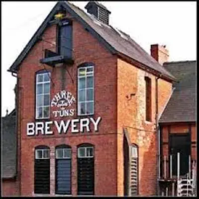 a brick building with a sign on the side of it at Llanhedric House in Clun