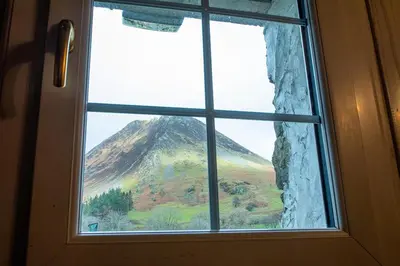 a view of a mountain through a window at Pant in Llanymawddwy