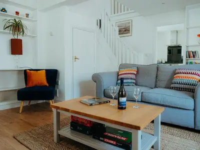 a living room with a blue couch and a table at The Coach House Barn in Shrewsbury