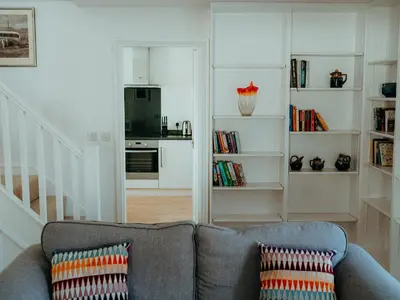 a living room with a couch and a kitchen at The Coach House Barn in Shrewsbury