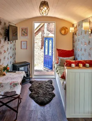 a living room with a couch and a blue door at Finest Retreats - Shrawardine Train Carriage in Shrawardine