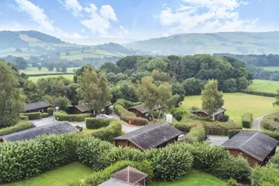 an aerial view of a home with trees and houses at Tawny Owl Lodge in Rhayader