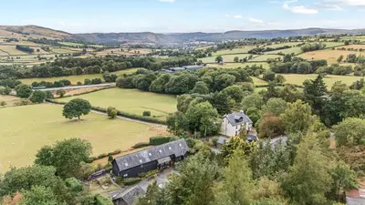 an aerial view of a house in a field at Great Owl Lodge in Rhayader