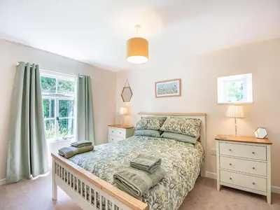 a bedroom with a bed and a window at Jackdaw Cottage in Knighton