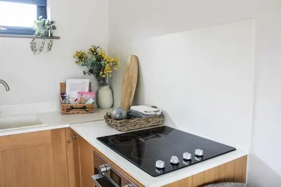 a kitchen with a stove and a counter top at The Tin Shed in Rhayader