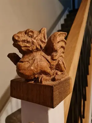 a statue of a dog sitting on the side of a staircase at Cosy Riverside home in Llanwrda