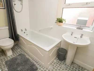 a bathroom with a tub and a sink and a toilet at The Ferns in Ludlow