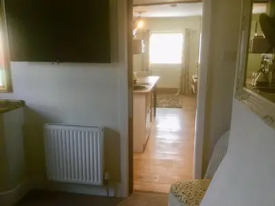 a room with a kitchen and a hallway with a hallway at HENWICK HOUSE Beautiful flat,Private parking, short walk to town in Ludlow