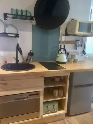 a kitchen counter with a sink and a microwave at HENWICK HOUSE Beautiful flat,Private parking, short walk to town in Ludlow