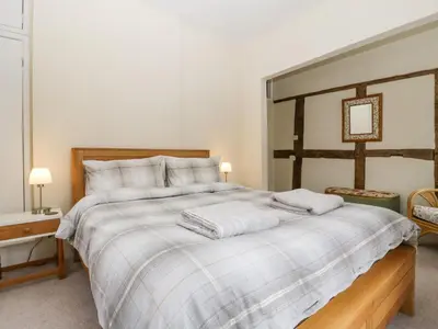 a bedroom with a large bed with two towels on it at The Old Rectory in Presteigne