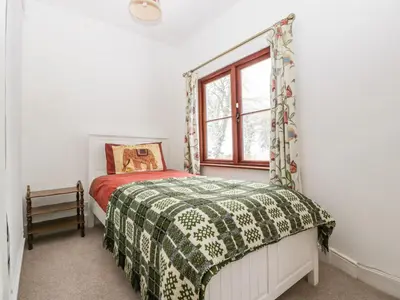 a bedroom with a bed and a window at The Old Rectory in Presteigne