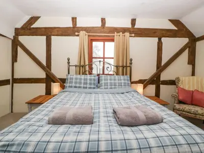 a bedroom with a bed with two pillows on it at The Old Rectory in Presteigne