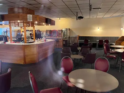 a restaurant with tables and chairs and a bar at welcome to B4 in Aberystwyth